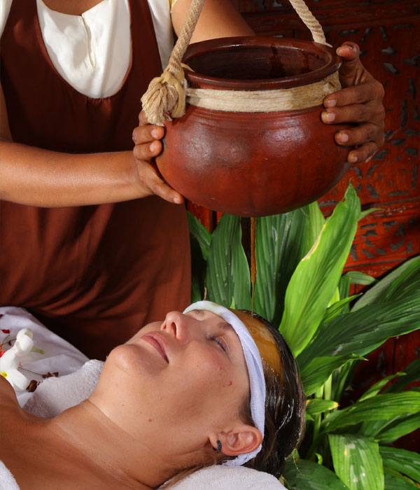 Woman receiving oil treatment