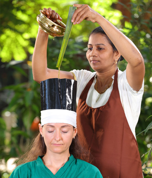 Women receiving hair treatment.