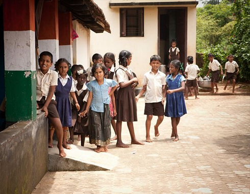 Group of kids in front of a local school.