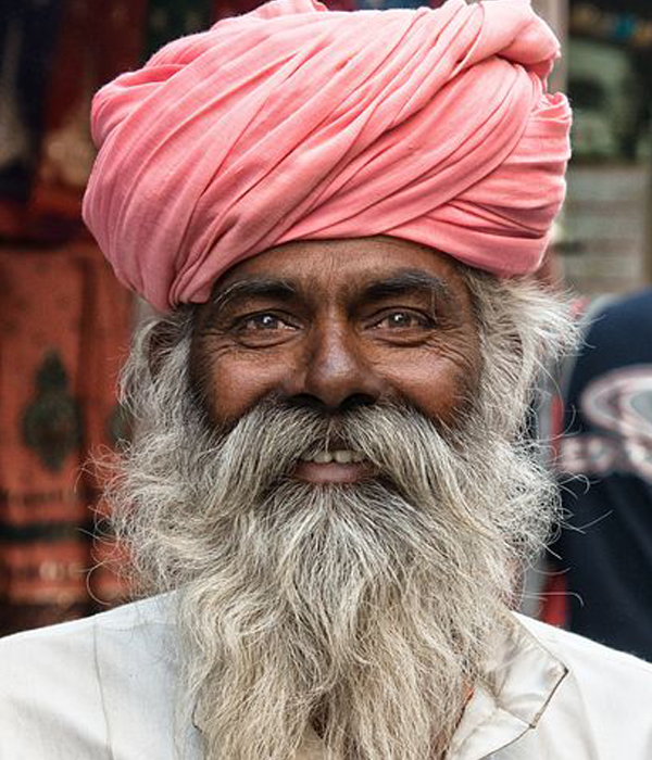 Old Indian man with a long grey beard.